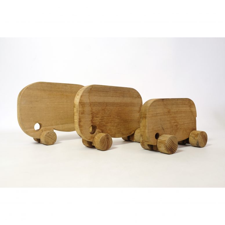 Set of three wooden vintage elephants on wheels.
