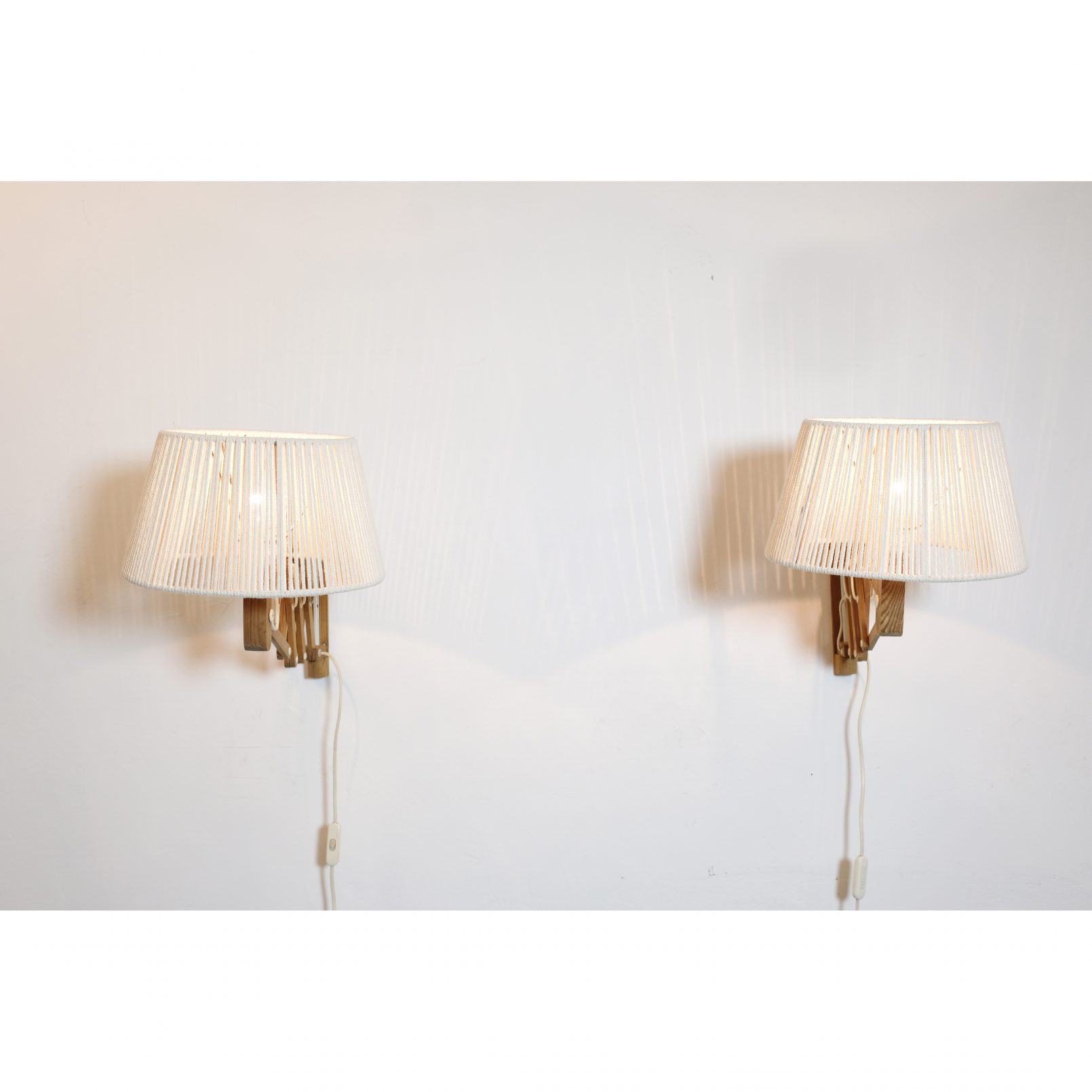 Pair of wooden wall mounted scissor lamps with cotton shades. — LampAndCo