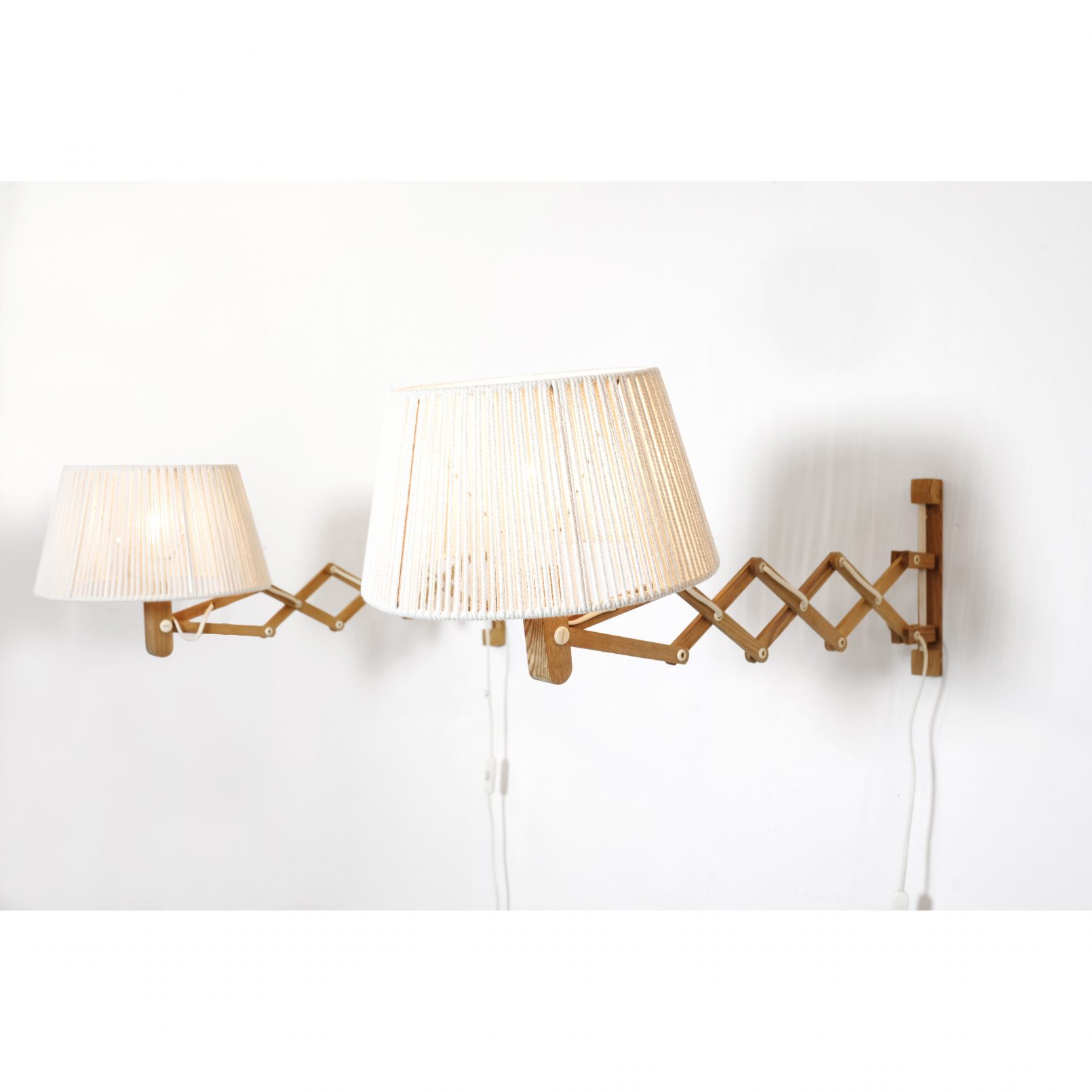Pair of wooden wall mounted scissor lamps with cotton shades. — LampAndCo