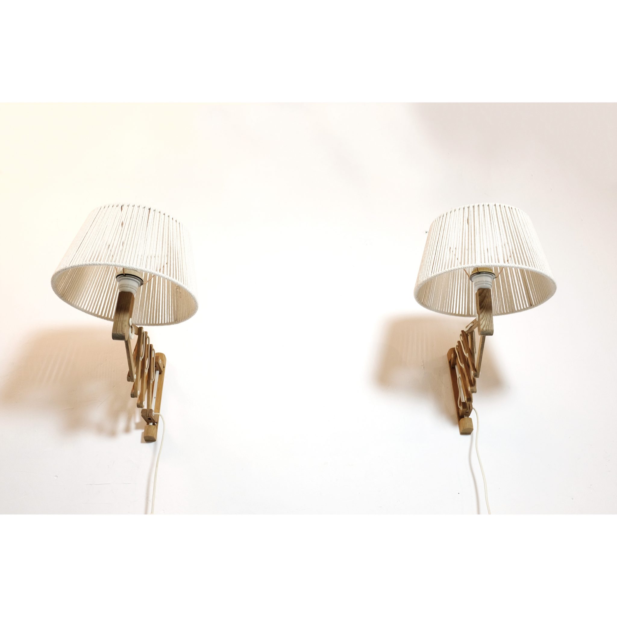 Pair of wooden wall mounted scissor lamps with cotton shades. — LampAndCo