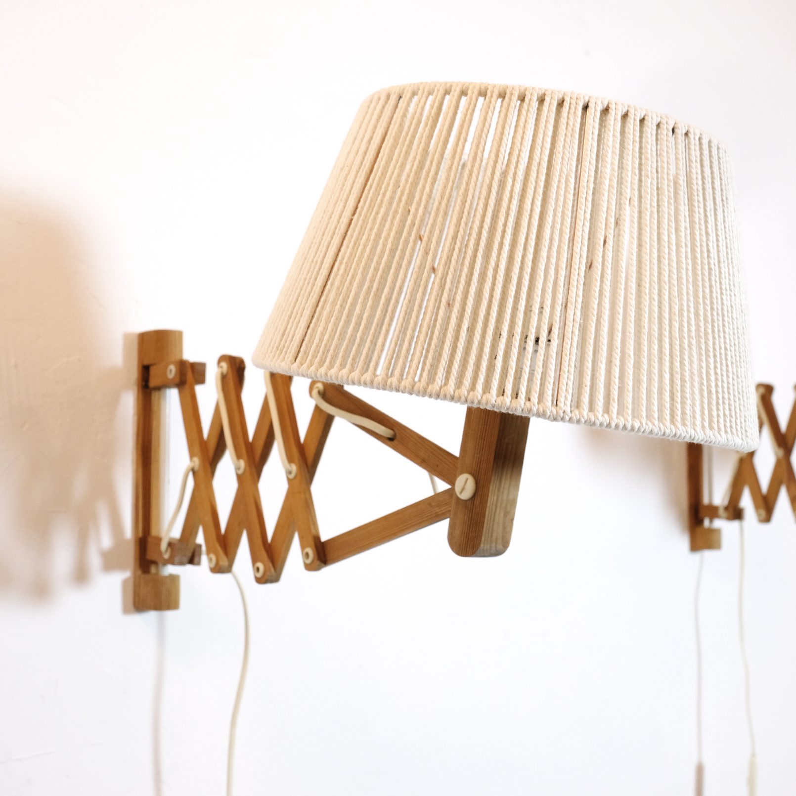 Pair of wooden wall mounted scissor lamps with cotton shades. — LampAndCo