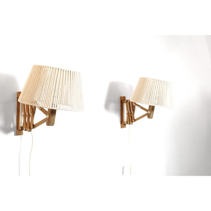 Pair of wooden wall mounted scissor lamps with cotton shades.