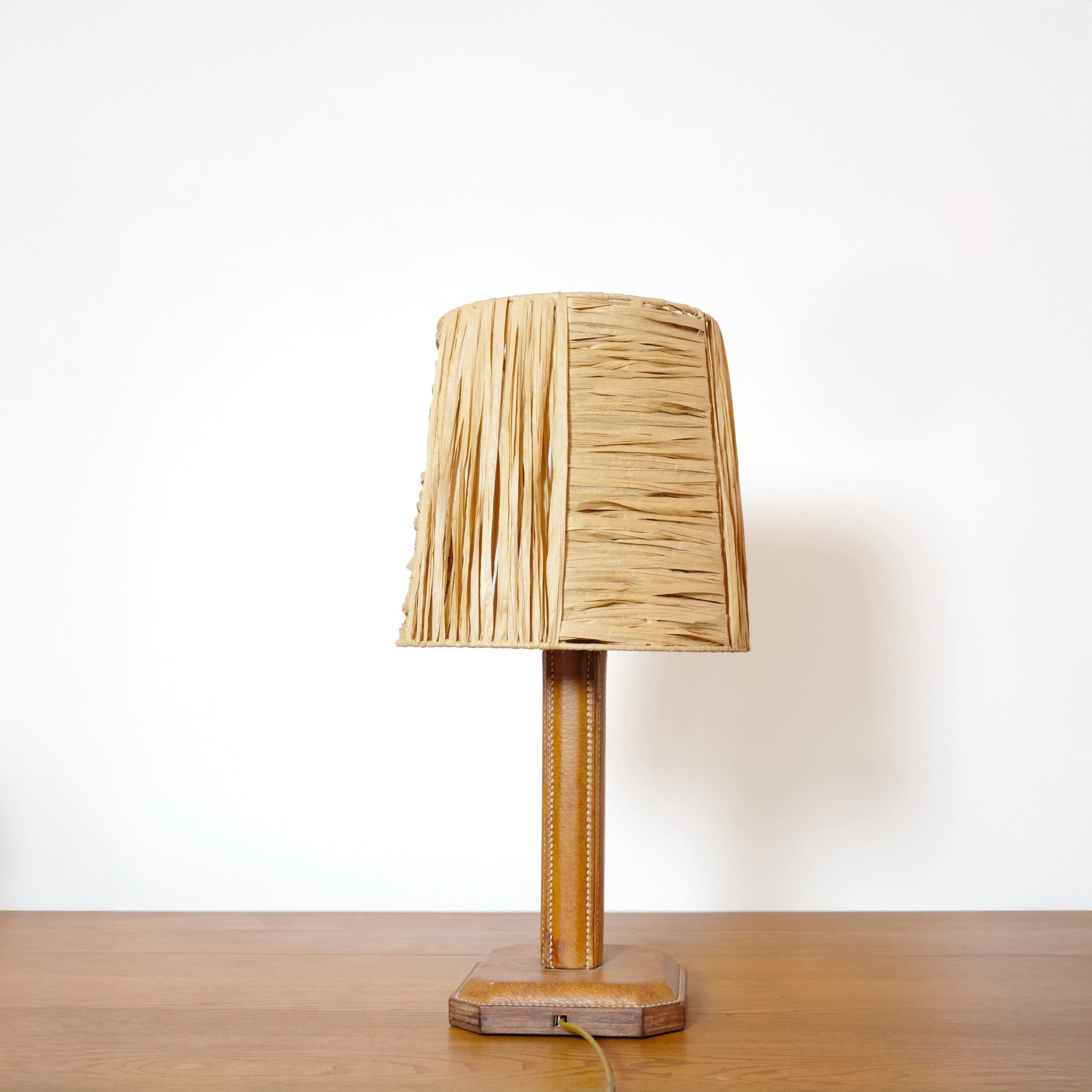 Leather table lamp and its raffia shade.