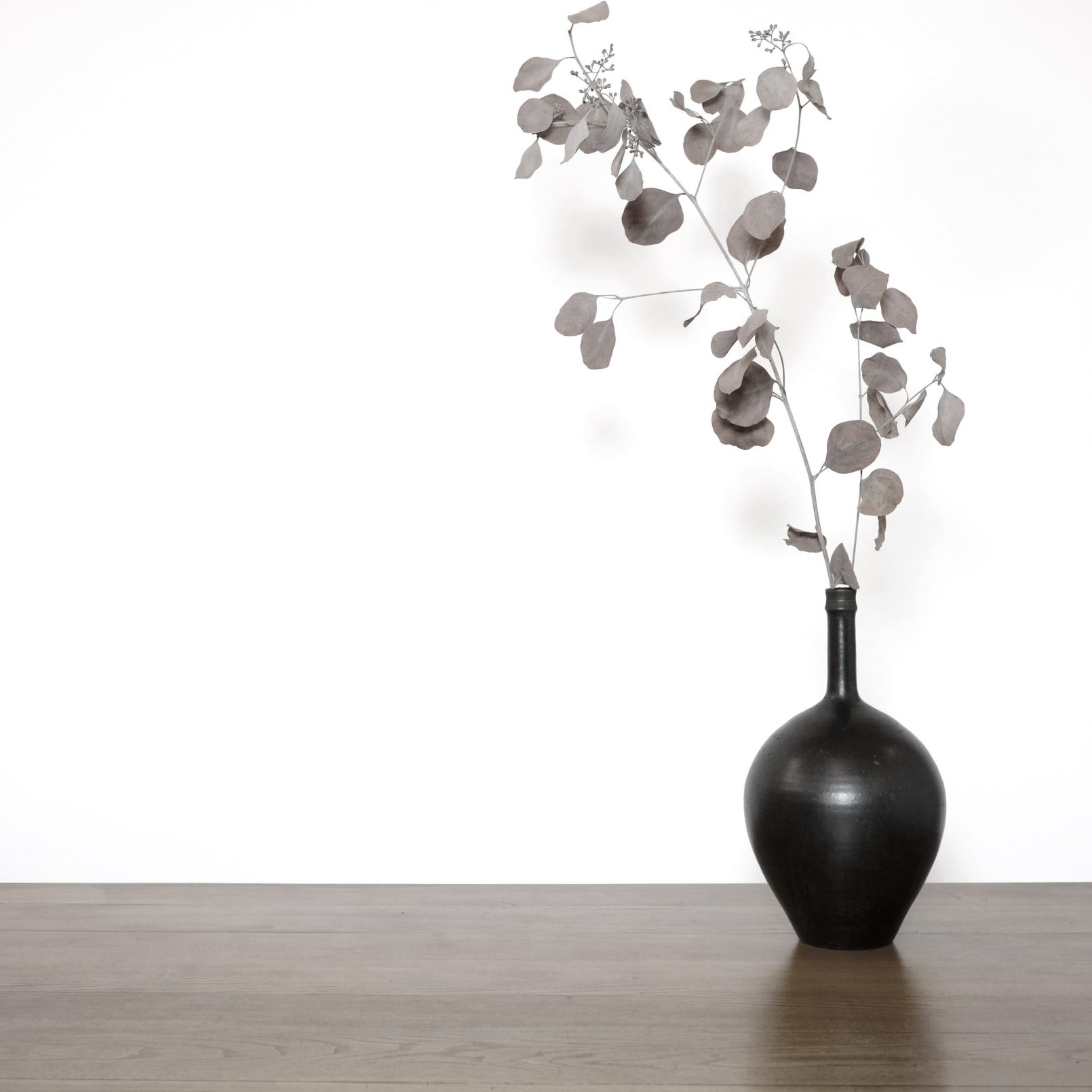 Narrow-necked stoneware vase with a dark glaze.