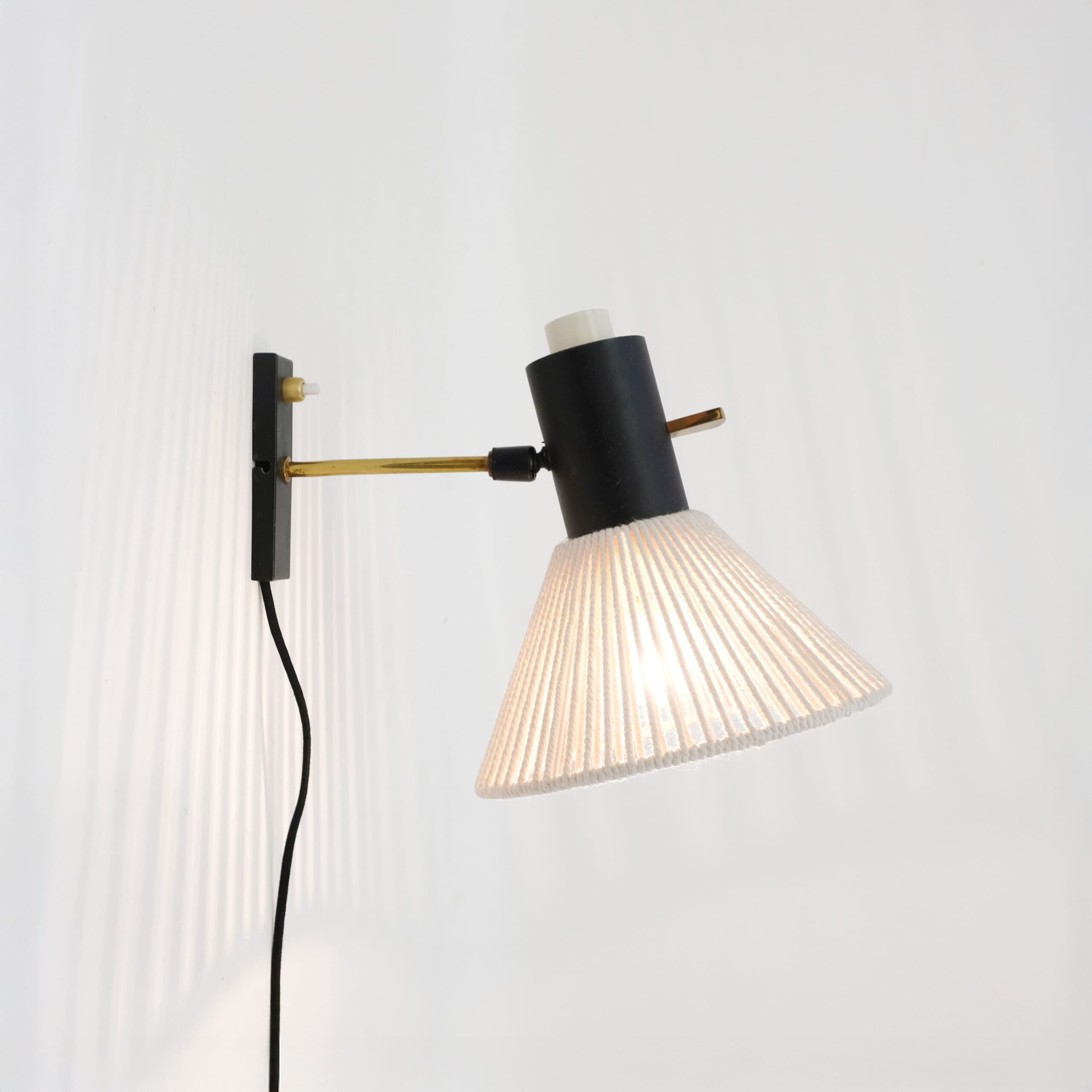 Brass and black lacquered metal wall lamp from the 1960s.