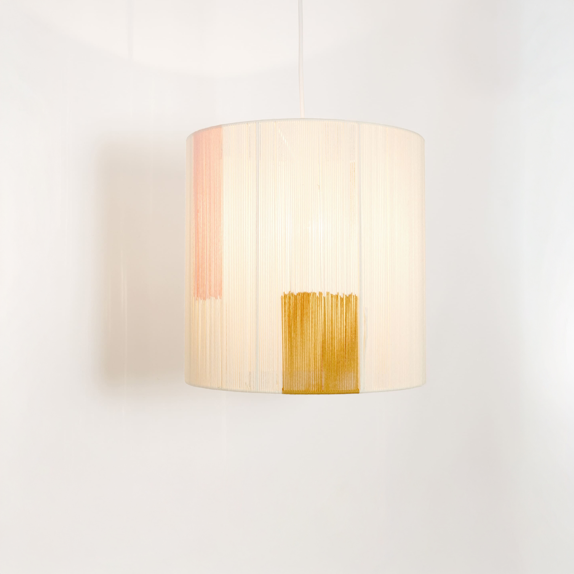 Handmade pendant lamp with a shade made of cotton threads.