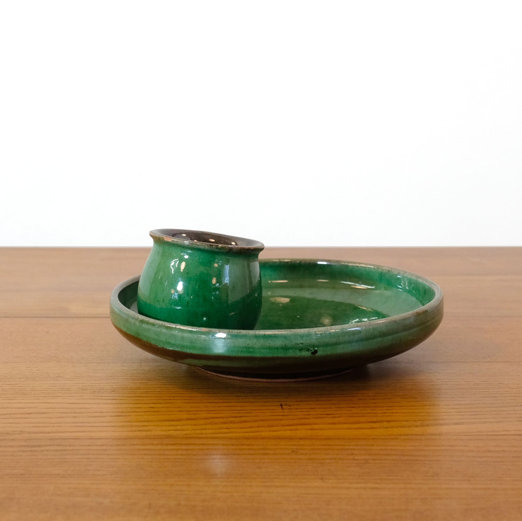 Green enameled earthenware candle holder.