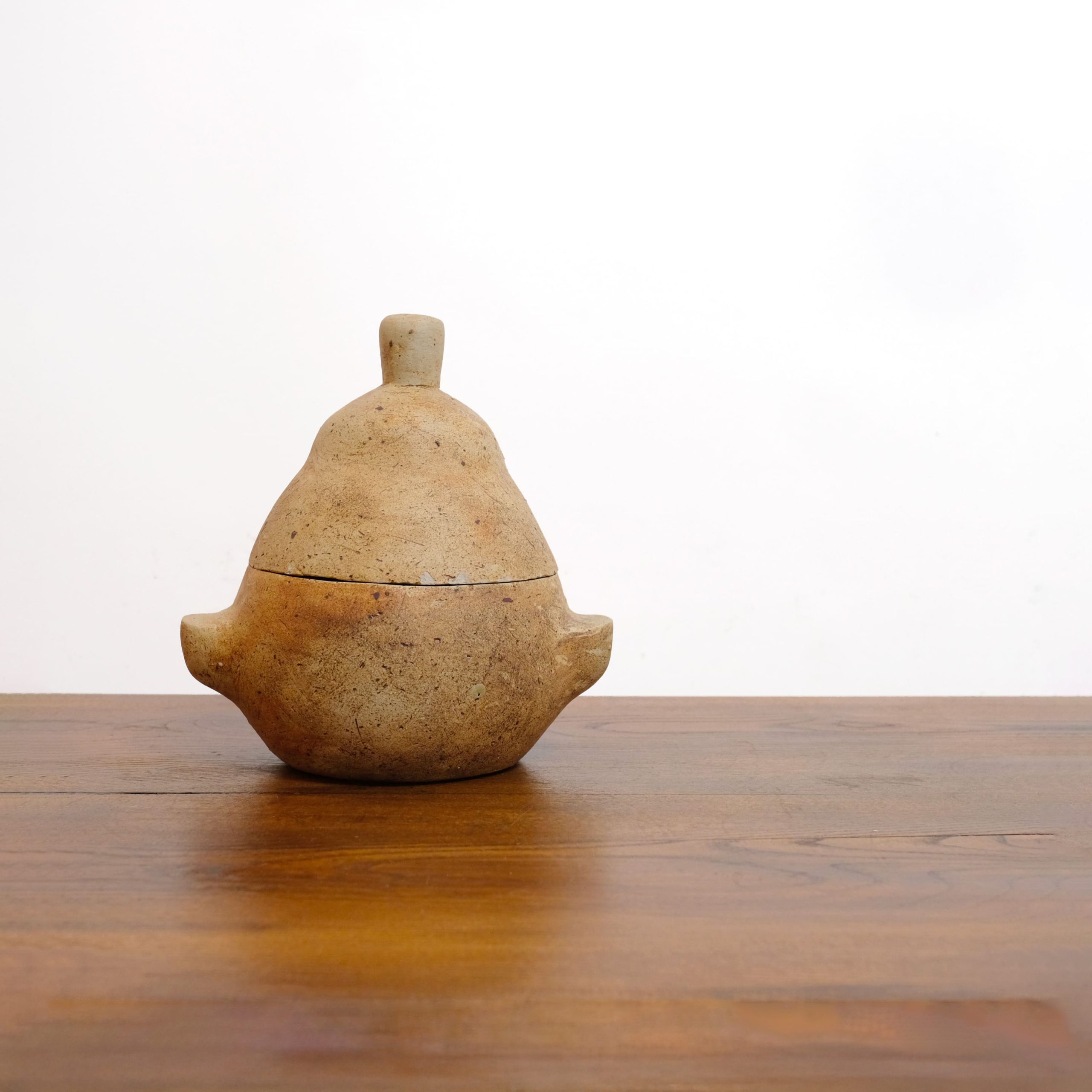 Pear-shaped stoneware covered pot.