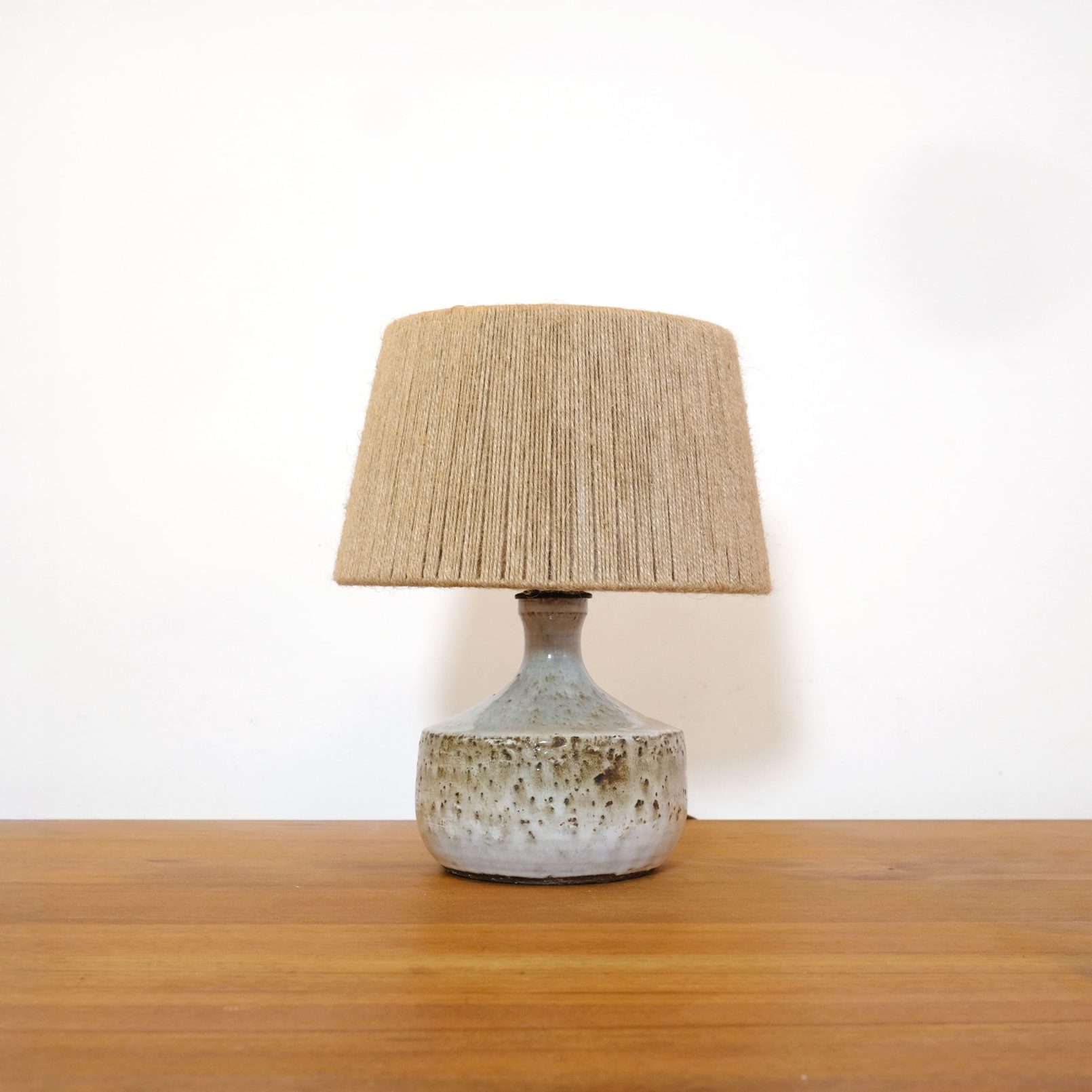 Enameled modernist stoneware lamp with its jute shade.